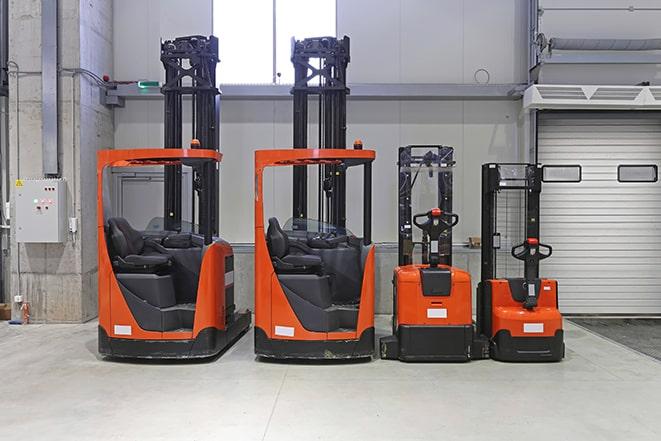 forklifts loading and unloading goods in a distribution center